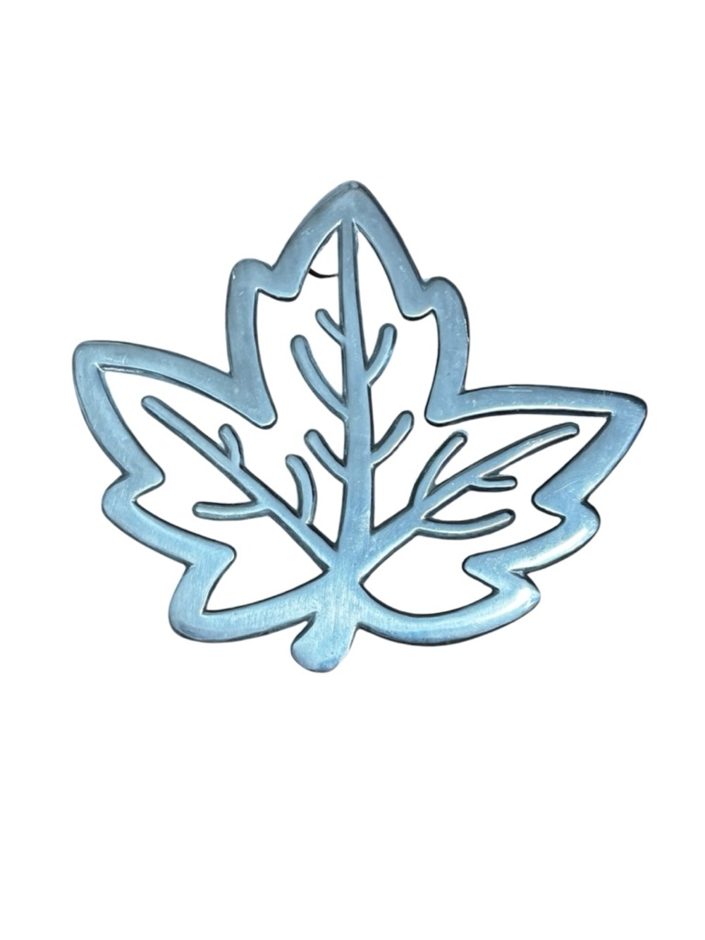 Copco cast aluminum heat resistant trivet featuring a maple leaf design.